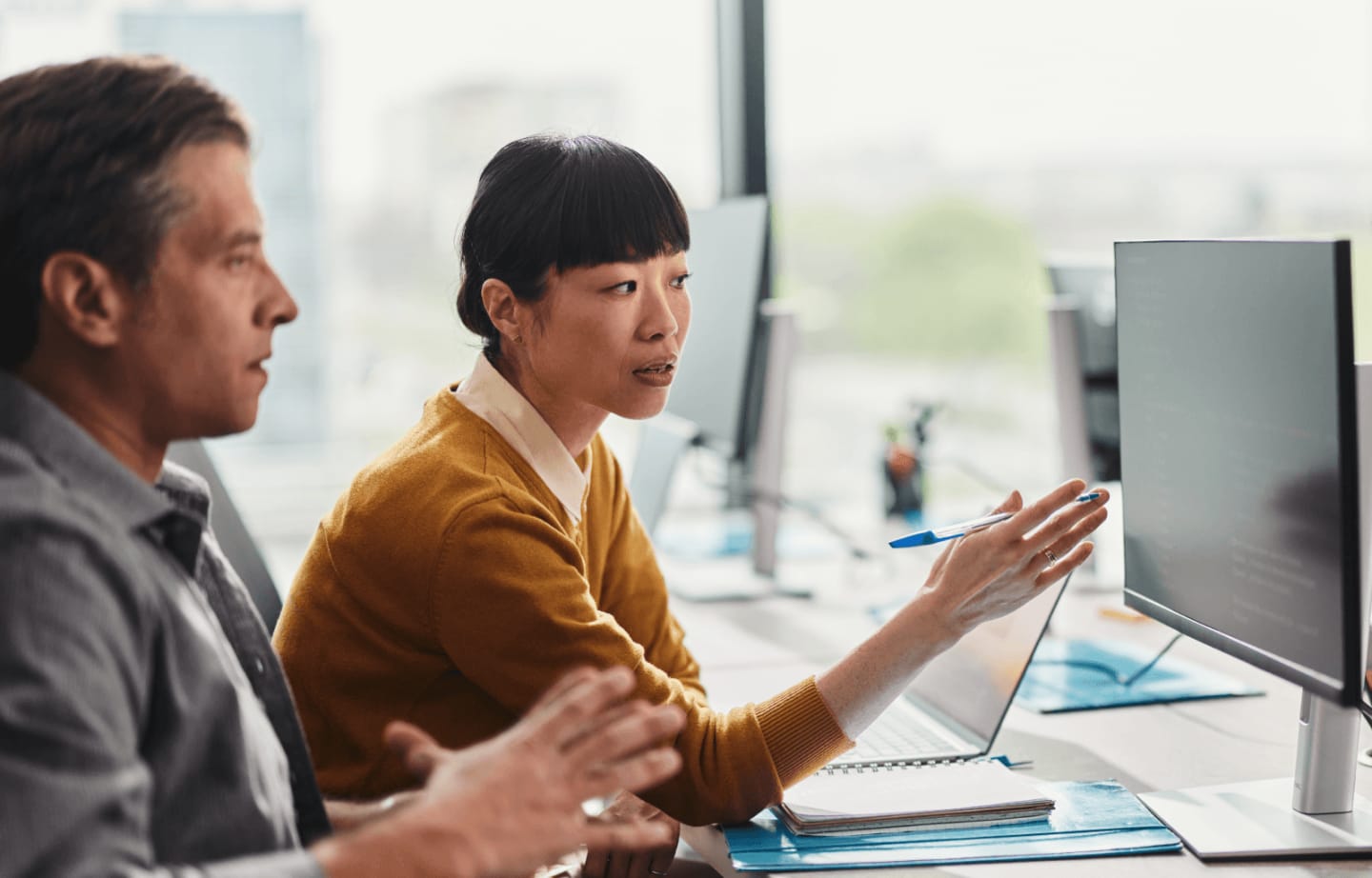 Two persons working on a computer