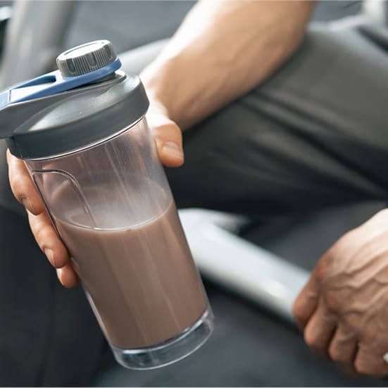 Man holding a supplement beverage