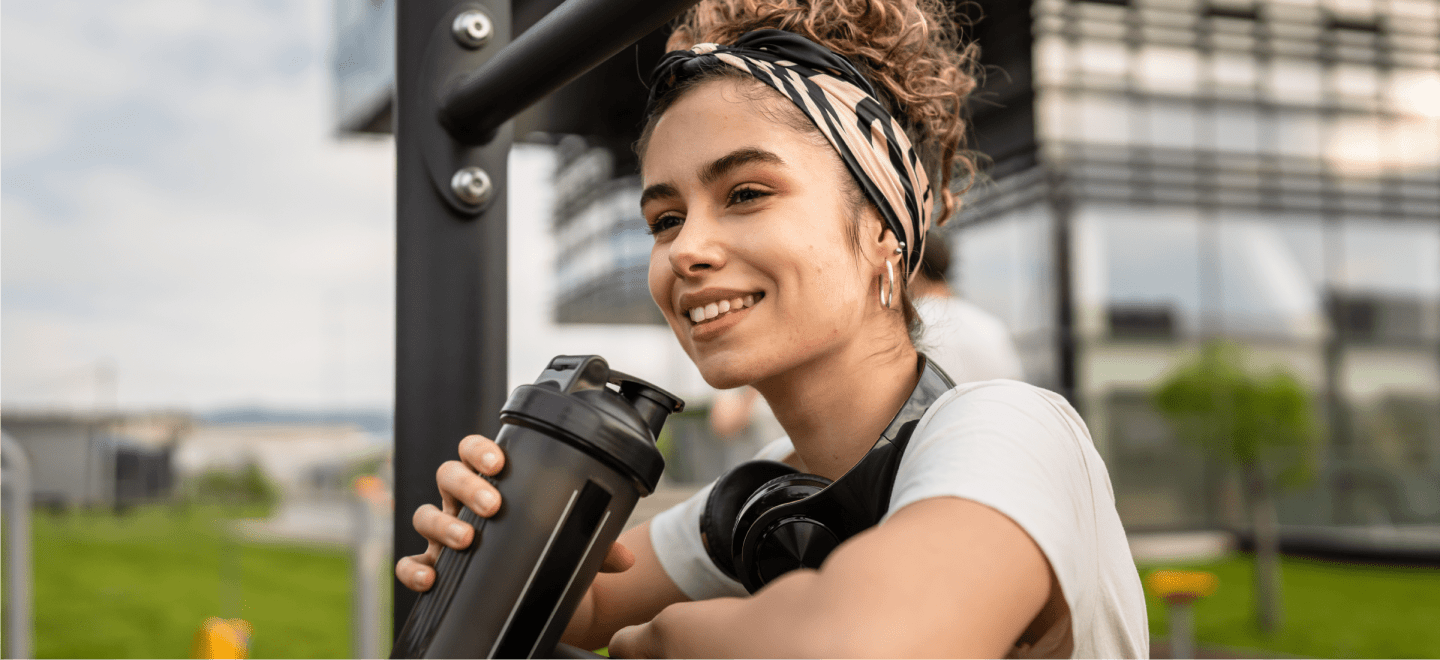Woman smiling drinking a beverage
