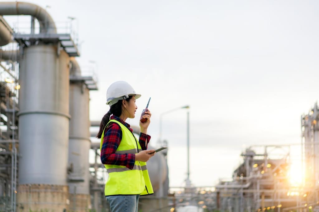 A photo depicts a field support person making a radio call
