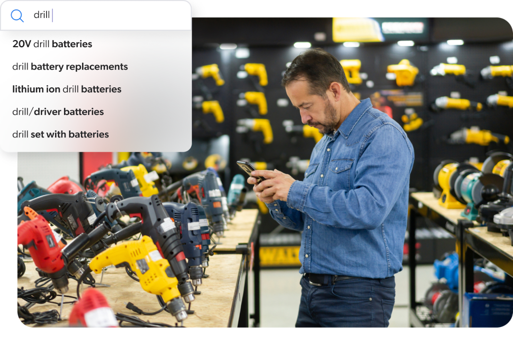 An image shows a man using a mobile device to search for “drill” and a query suggest feature offering different permutations of the term.