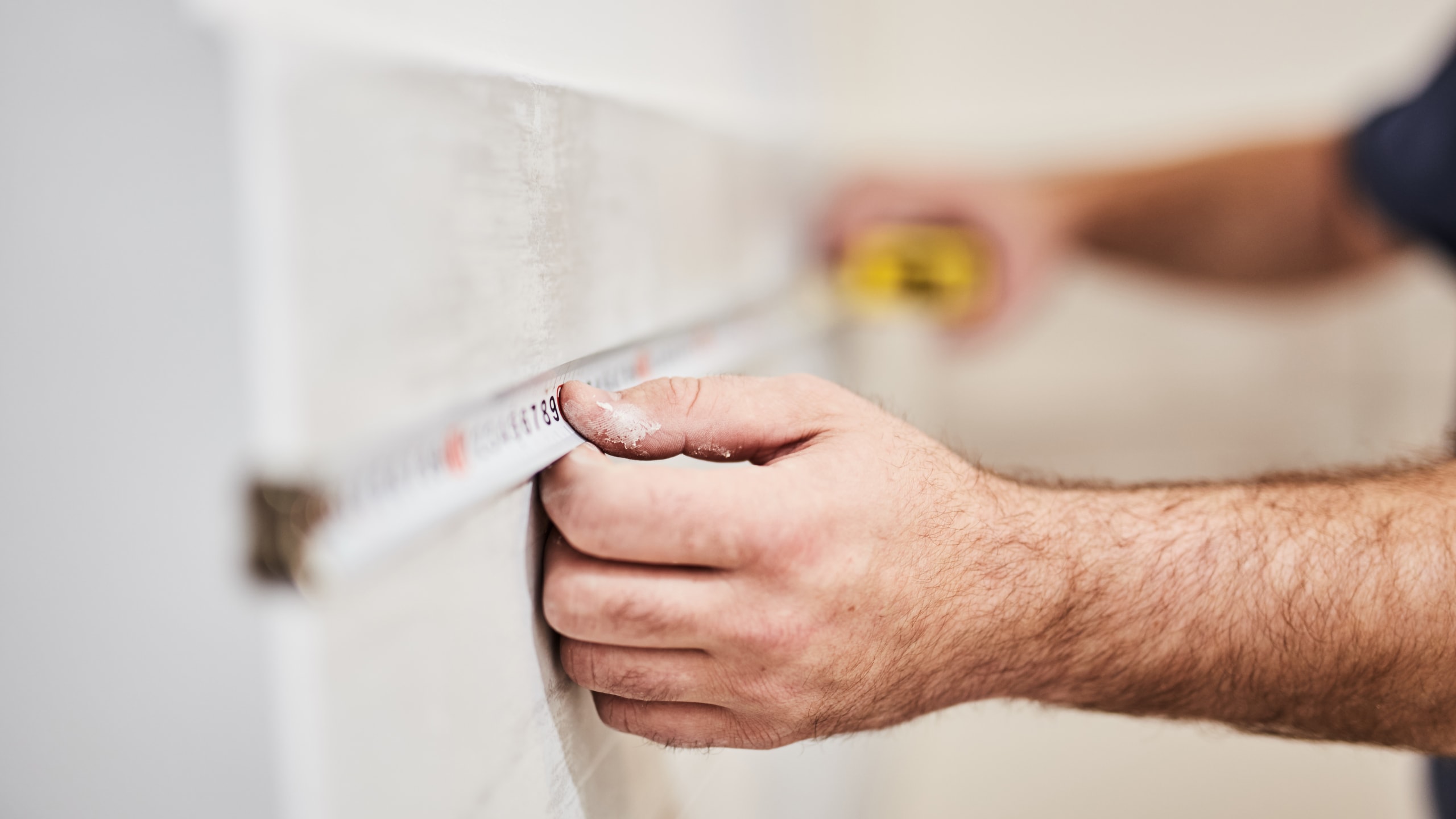 Worksman using tape measure for home renovation. Similar to the tape measure, you need a framework to measure search relevance.