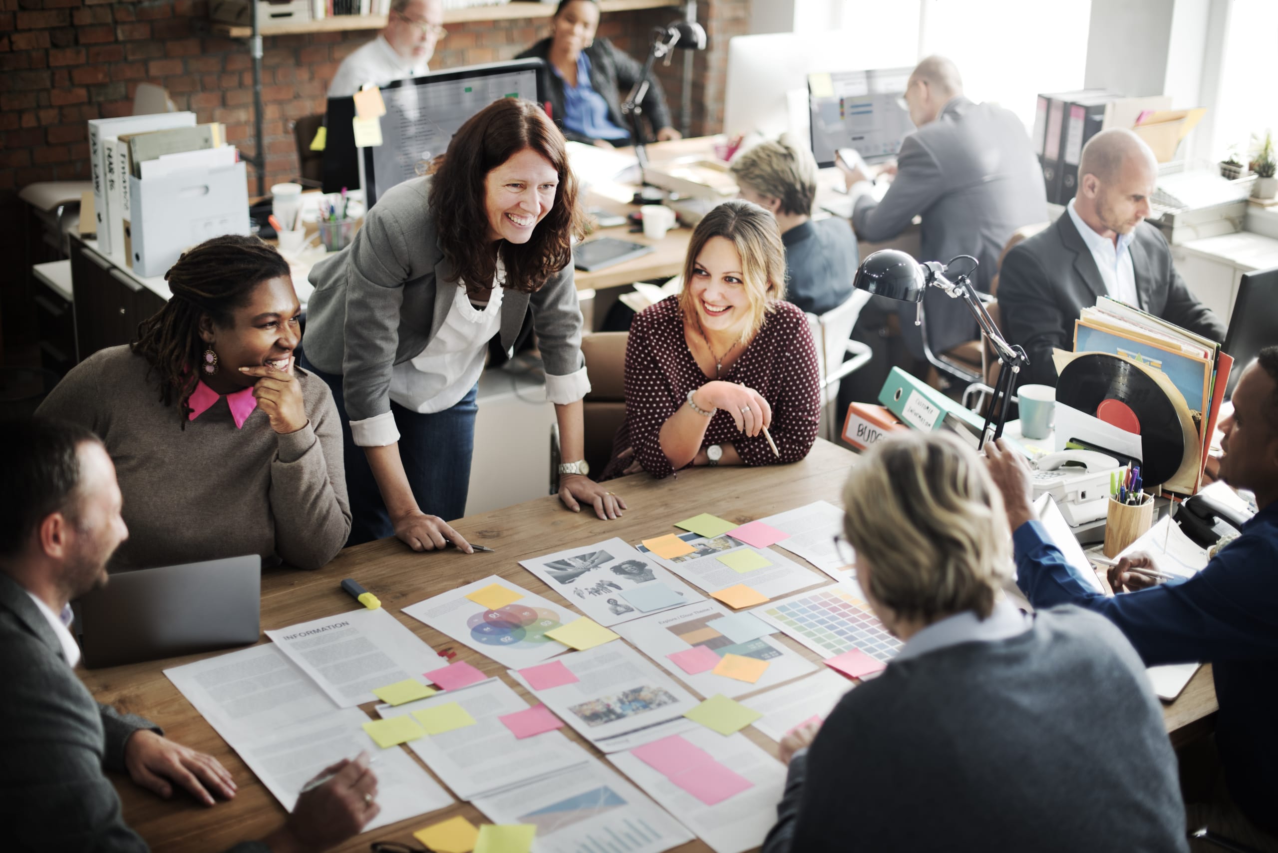 An image shows intelligent swarming in the form of employees collaborating.