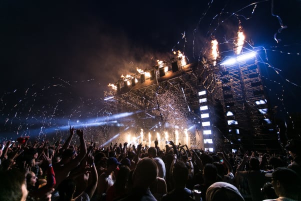 An image of a concert stage - fireworks are going off.