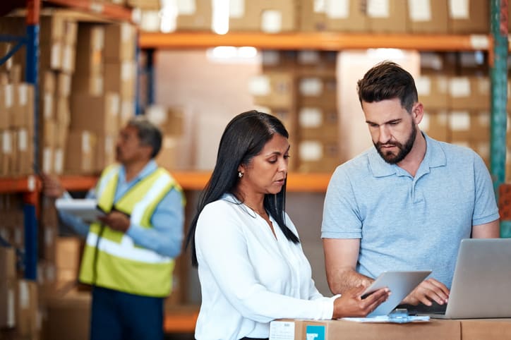 Shot of a man and a woman using a digital tablet while working together in a warehouse